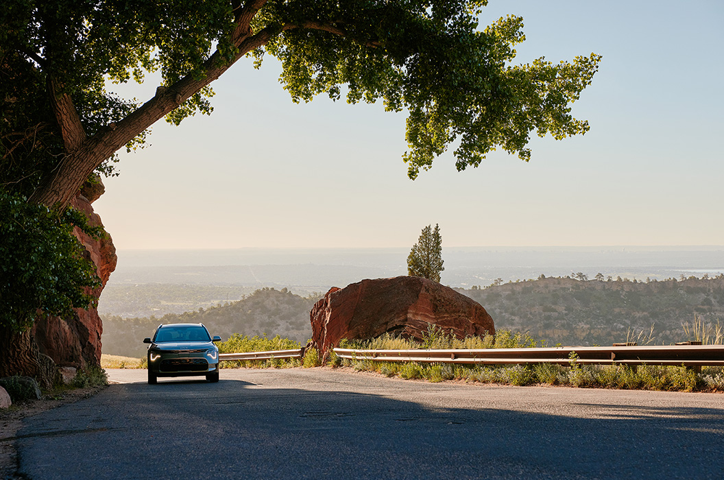 Electric vehicle driving through Colorado’s red rock landscape