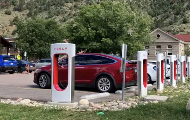 Tesla EV chargers in a parking lot.