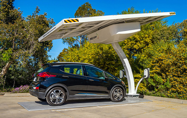 An electric vehicle parked at a solar-powered EV charging station