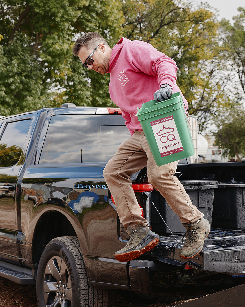 Man stepping down out of the bed of a truck