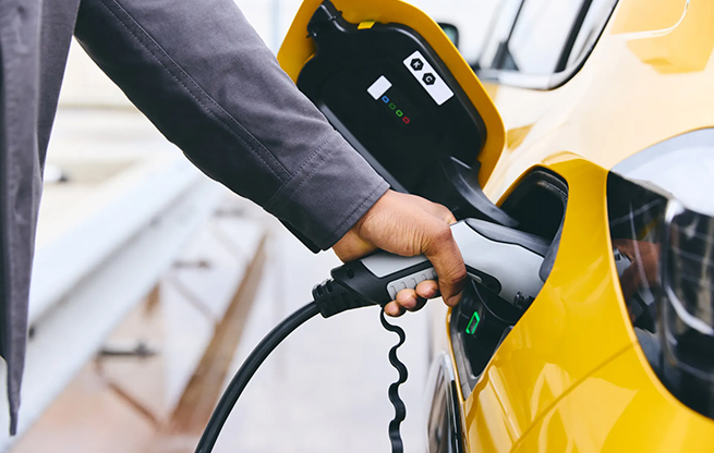 Man charging yellow car