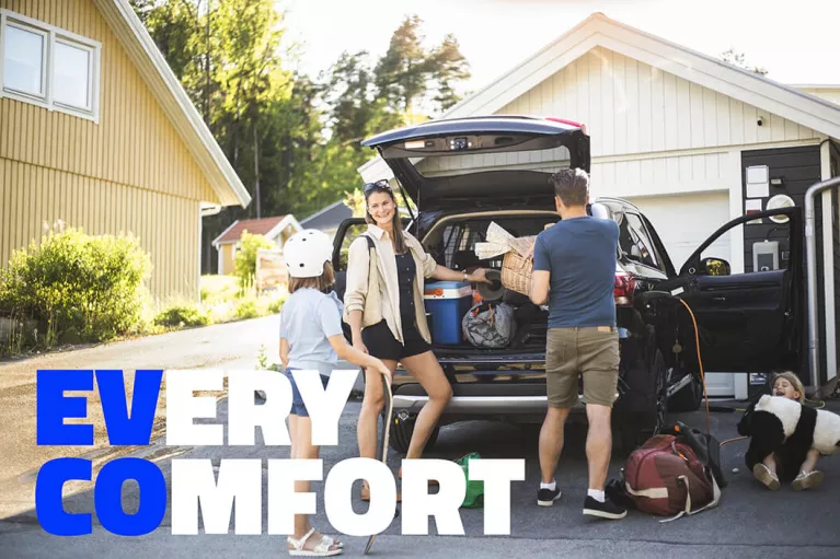 EV CO: Every Comfort. A family loading up an EV before a trip.