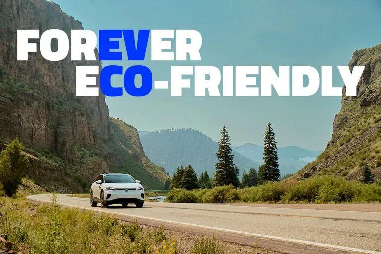 EV CO: Forever Eco-Friendly. An electric vehicle driving along a road.