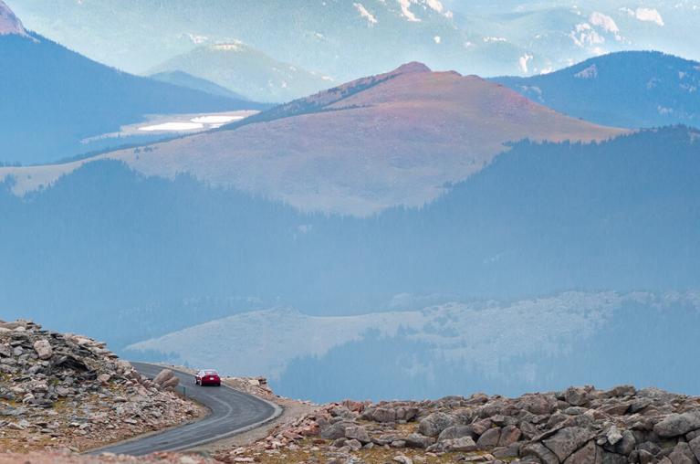 A car driving in the mountains.