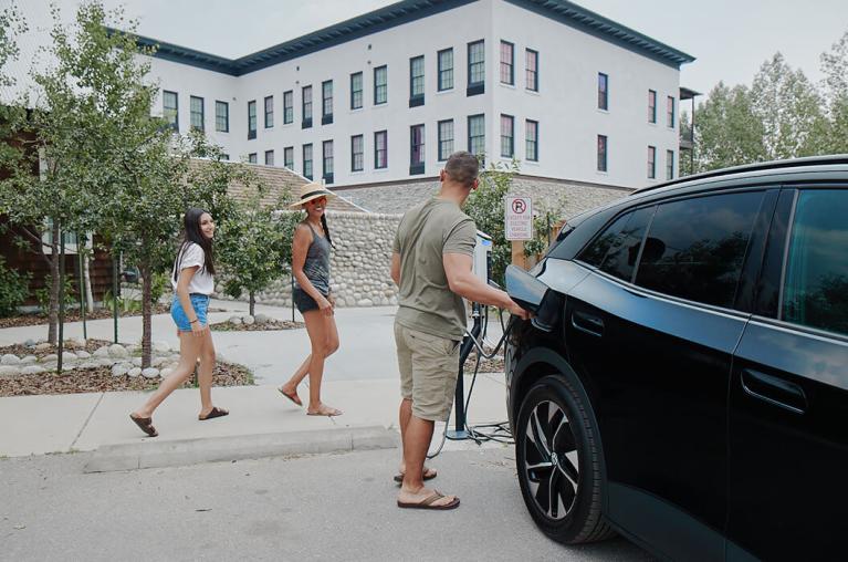 People walking around near a vehicle.