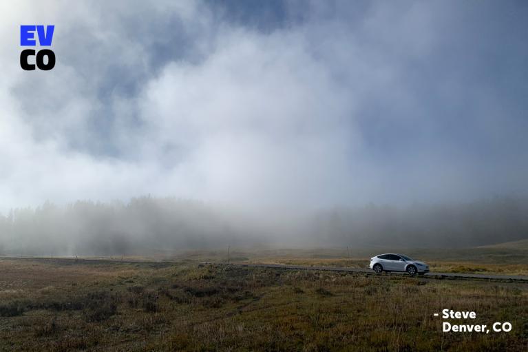 An image of an EV in the distance, with fog the behind it blurring the trees in the background.