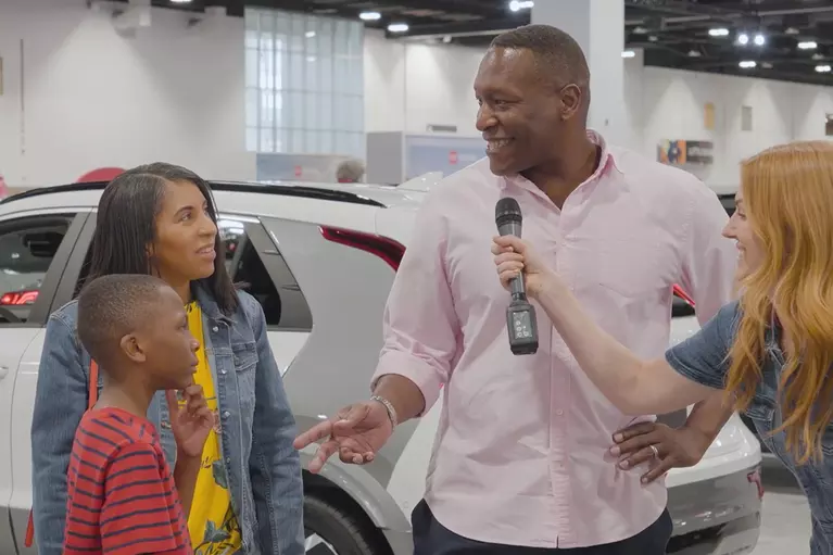 A man conversing with his family while answering a trivia question